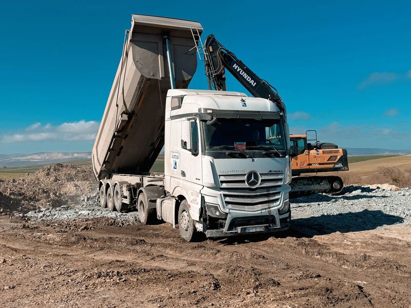 Tipper lorry being loaded by an excavator